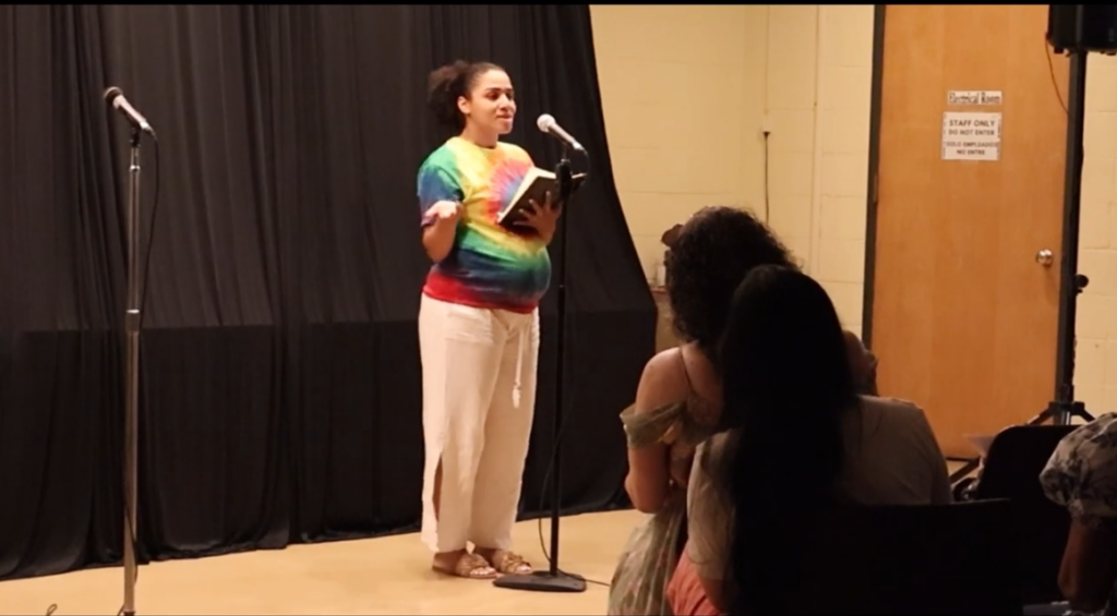 Allie Brown performing at StorySlam at the Johnson Public Library